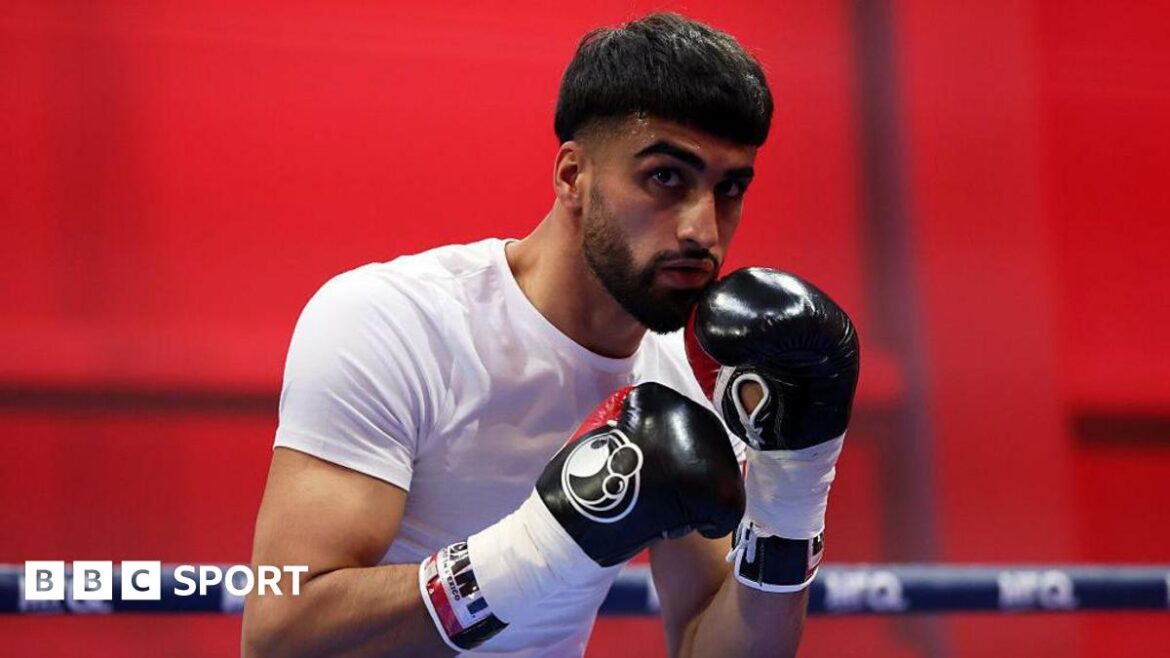 Adam Azim with his hands up