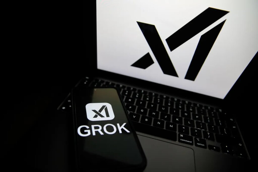 The Grok logo appears on a phone and the xAI logo is displayed on a laptop.