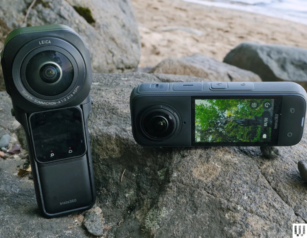 Two Insta360 cameras long rectangular black devices on a beachside rock.