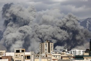 Smoke rises from the area after it was targeted in attacks as a series of explosions are heard in Tehran, Iran on March 01, 2026. The Islamic Republic of Iran Broadcasting (IRIB) building after Iranian authorities said it was targeted in the attacks.