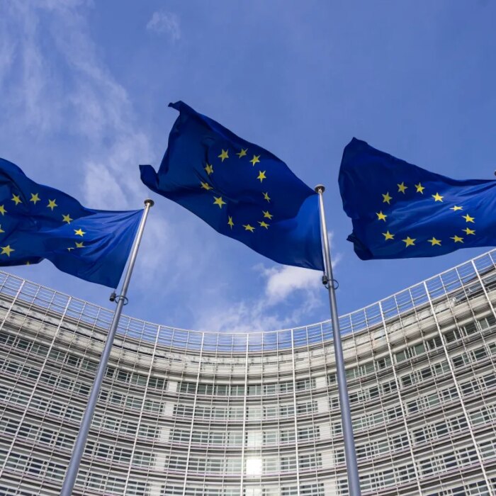 Flags of Europe as seen waving from the flagpoles in front of the EU Commission headquarters.
