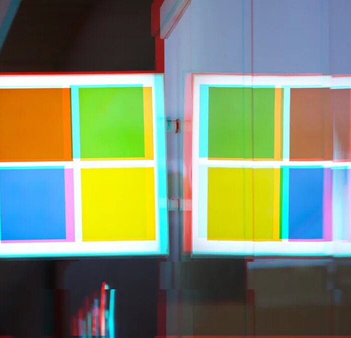 A moshed/glitchy version of a Windows logo on a Microsoft Store front.