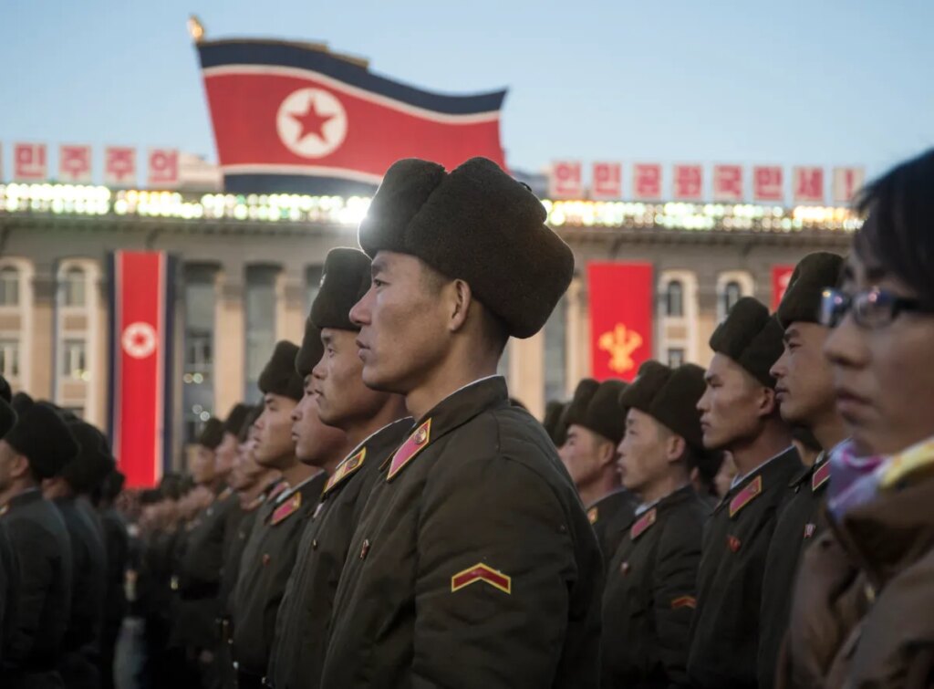North Korean soldiers attend a mass rally to celebrate the North