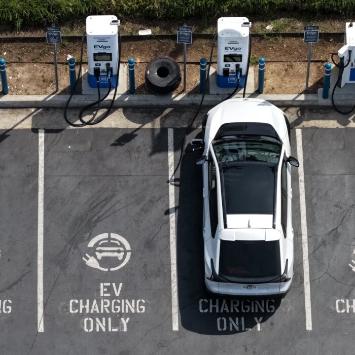 In an aerial view, an electric vehicle charges at an EVgo electric charger on March 30, 2026, in Monrovia, California.