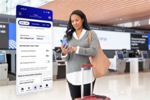woman checking cell phone in airport lobby