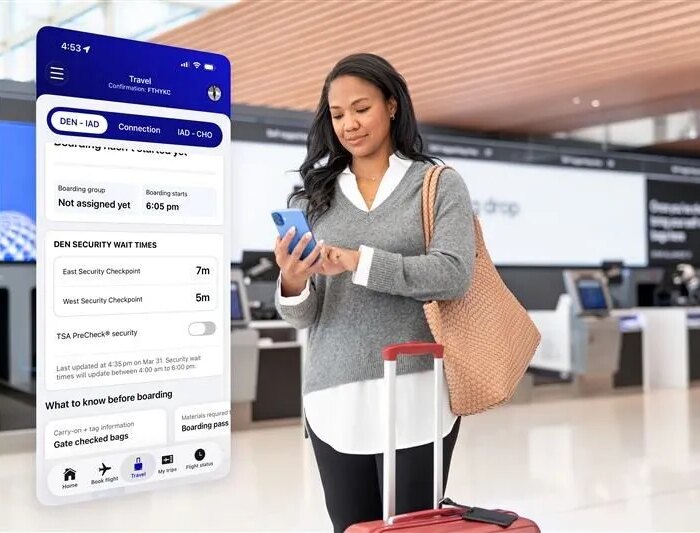 woman checking cell phone in airport lobby
