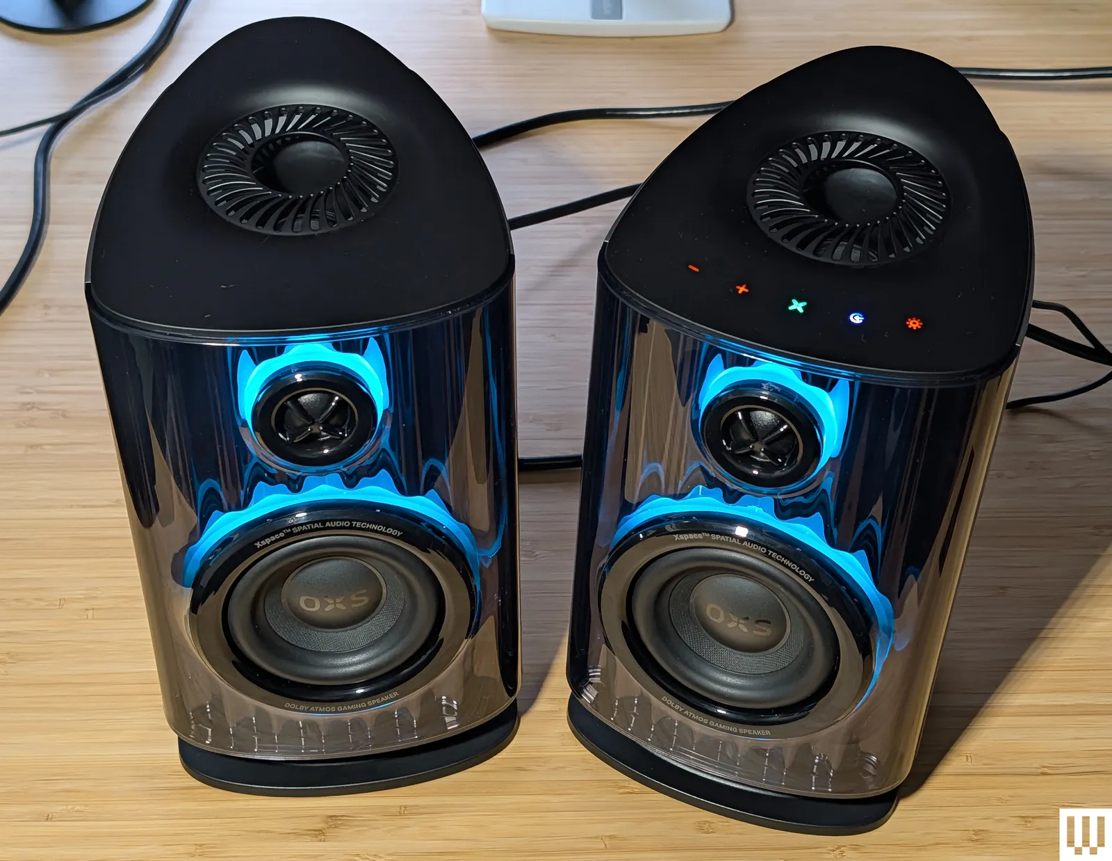 Black desktop speakers with blue lighting