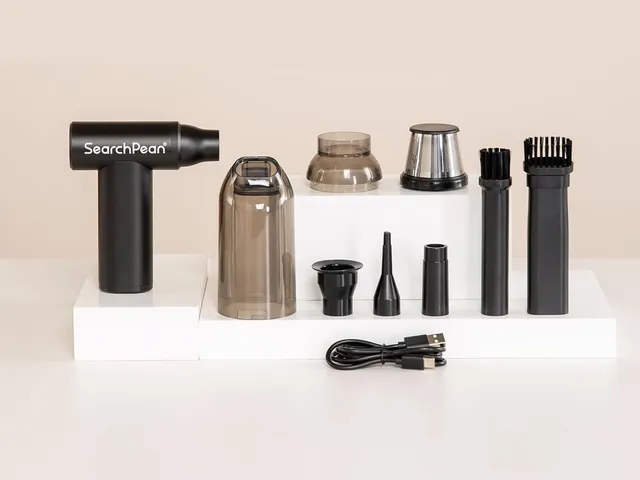 Small handheld vacuum and attachments on white platforms for presentation