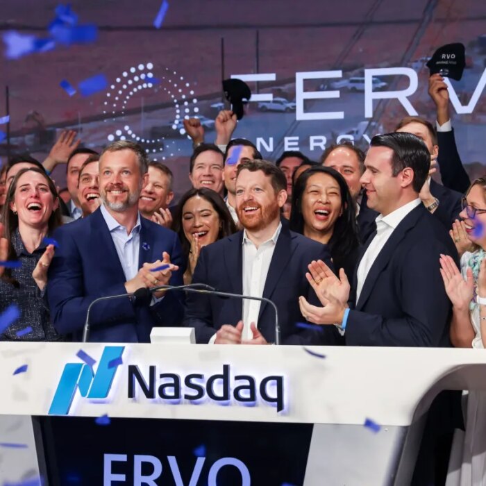People applauding a new stock listing on the Nasdaq.