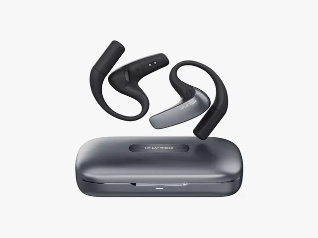 Black and grey earbuds hovering over a closed case