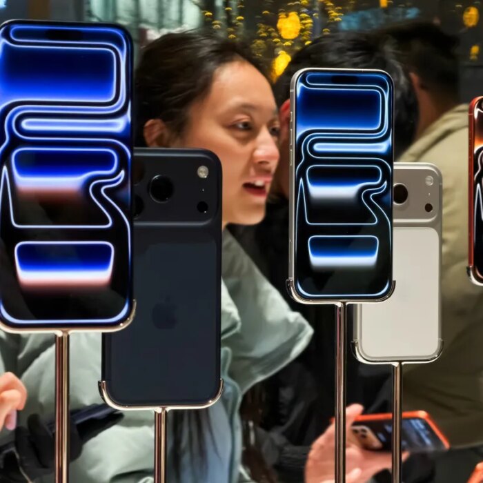 Customers try out iPhone 17 Pro smartphones inside the Apple Store at Sanlitun Taikoo Li on November 8, 2025, in Beijing, China.