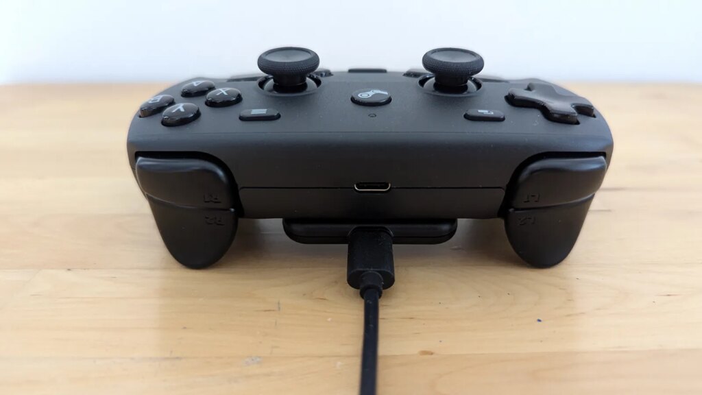 A top view of the Steam controller with it's accessory cable connected