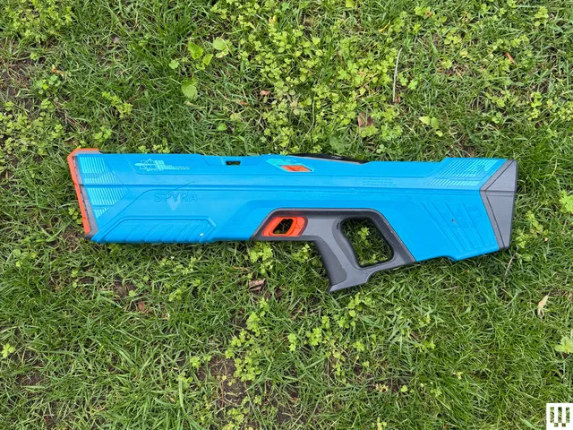 Blue water gun in the grass