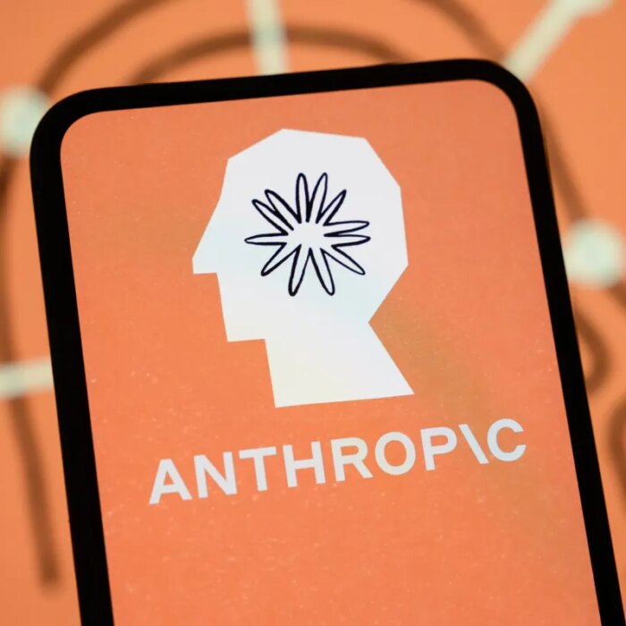 The Anthropic logo is displayed on the screen of a smartphone with the company