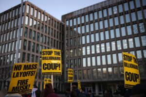 Demonstrators gather outside of the Office of Personnel Management in Washington, D.C. on February 7, 2025 to protest federal layoffs and demand the termination of Elon Musk from the Department of Government Efficiency (DOGE). (Photo by Bryan Dozier / Middle East Images / Middle East Images via AFP)