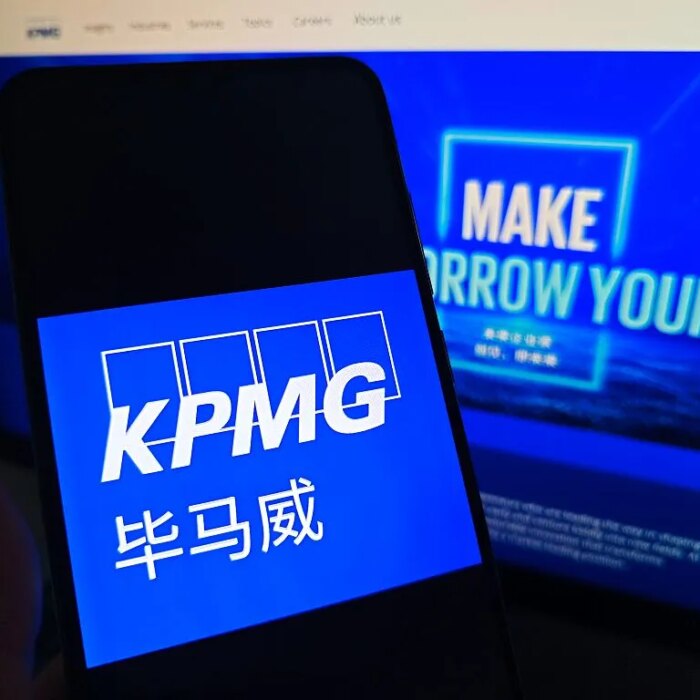 SUQIAN, CHINA - MAY 19, 2026 - A netizen is checking KPMG logo on his mobile phone and KPMG webpage on his computer in Suqian City, Jiangsu Province, China on May 19, 2026. (Photo credit should read CFOTO/Future Publishing via Getty Images)