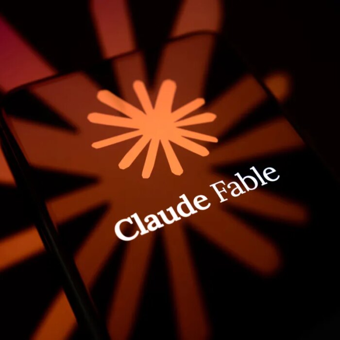The Claude Fable logo is displayed on the screen of a smartphone placed on a reflective surface onto which the company
