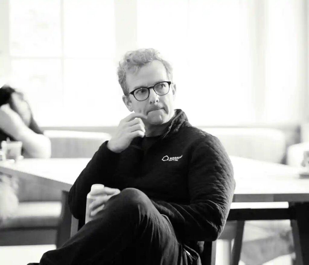 Mike Schroepfer sits in a chair.