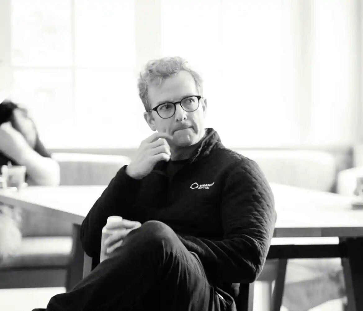 Mike Schroepfer sits in a chair.