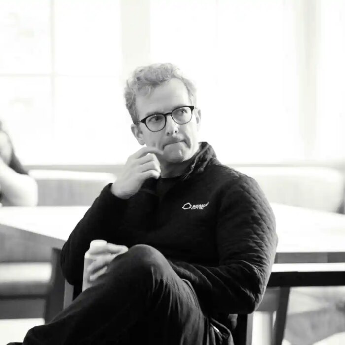 Mike Schroepfer sits in a chair.