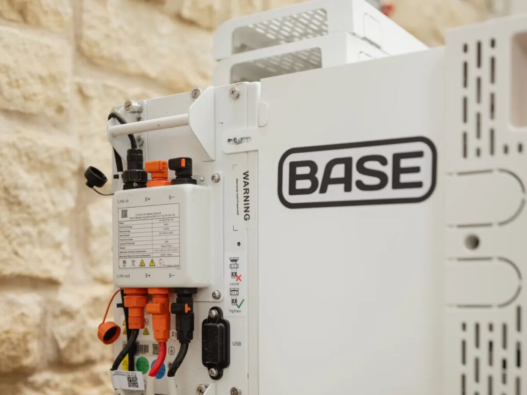 A Base Power battery sits next to a home.