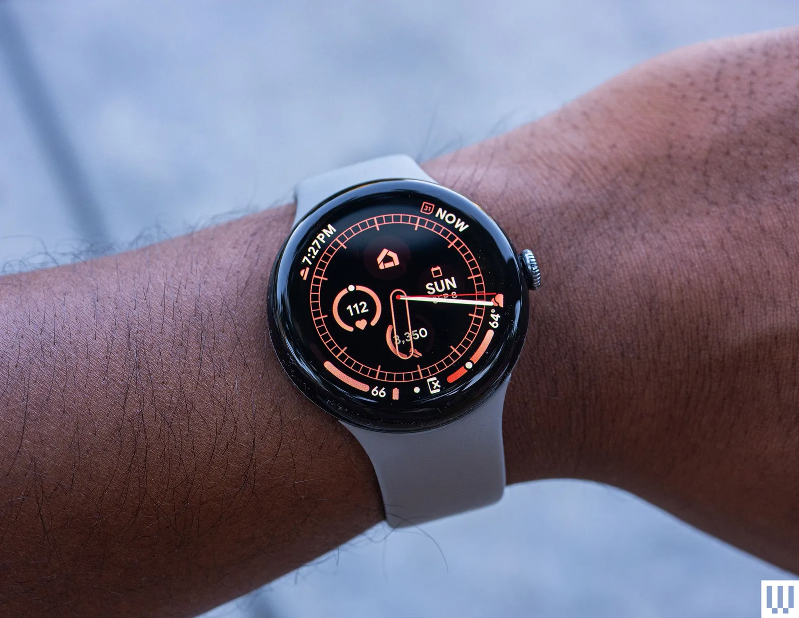 Person's wrist wearing a Google Pixel Watch 3 a smartwatch with the screen showing time date and health metrics such as...