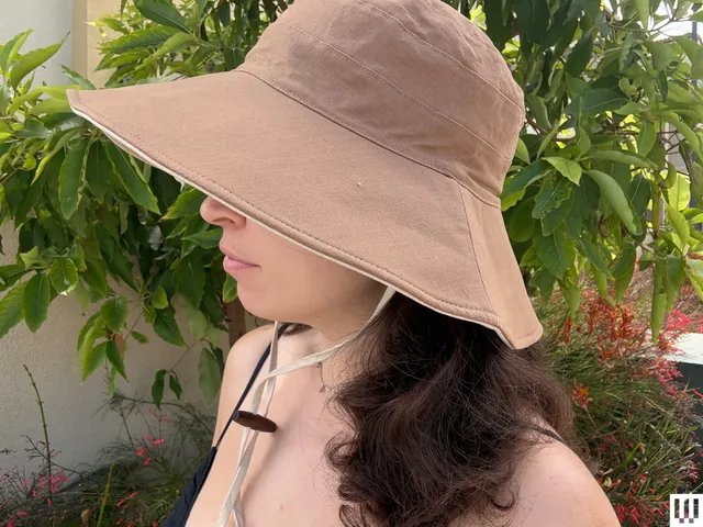 Image may contain: Clothing, Hat, Sun Hat, Adult, and Person