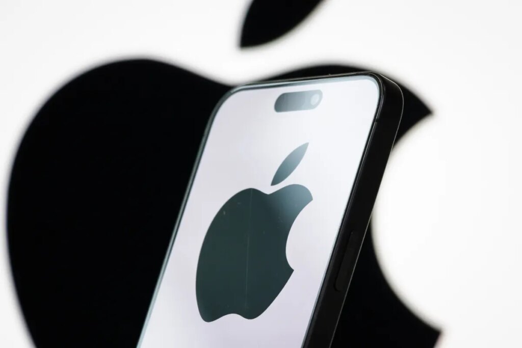 In this photo illustration, the logo of Apple Inc. is displayed on a smartphone screen, with the company