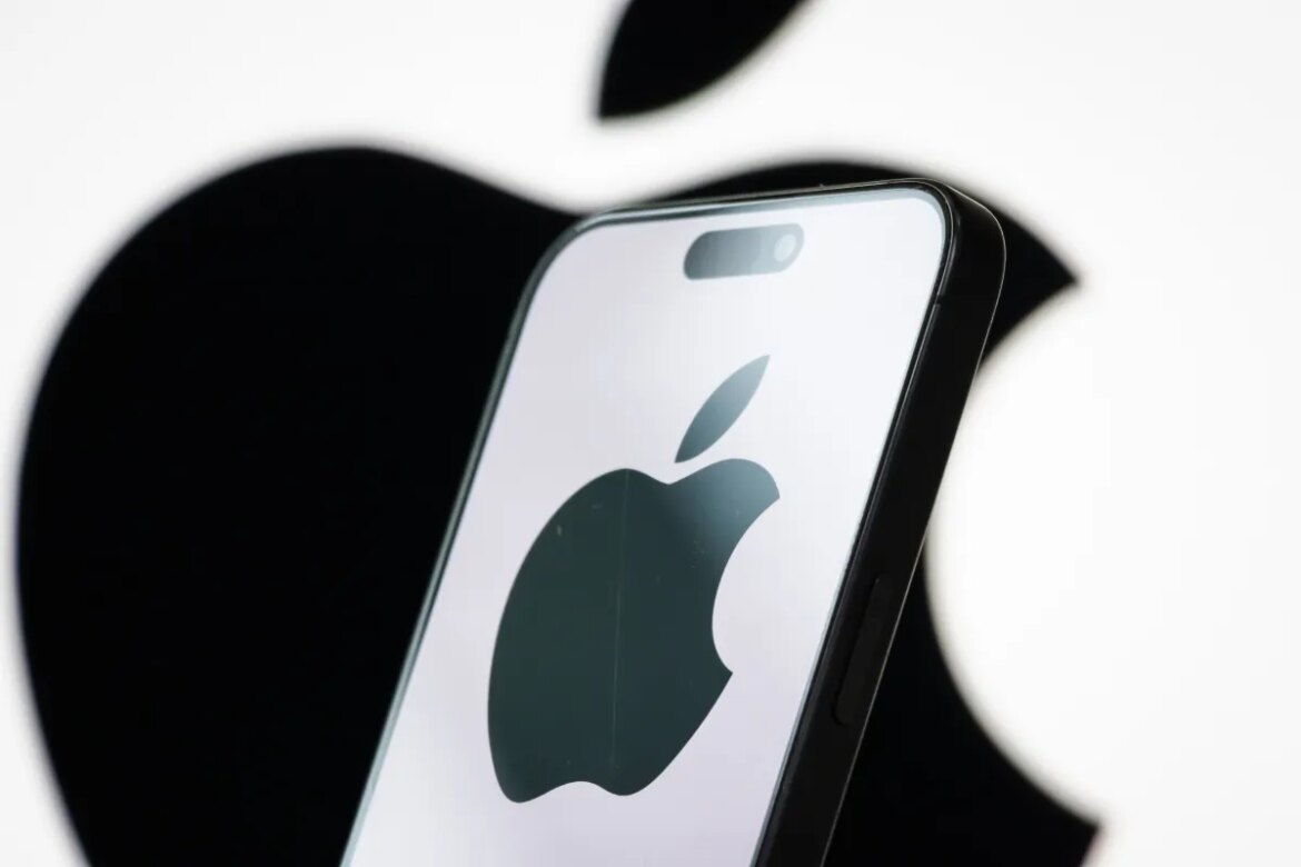 In this photo illustration, the logo of Apple Inc. is displayed on a smartphone screen, with the company