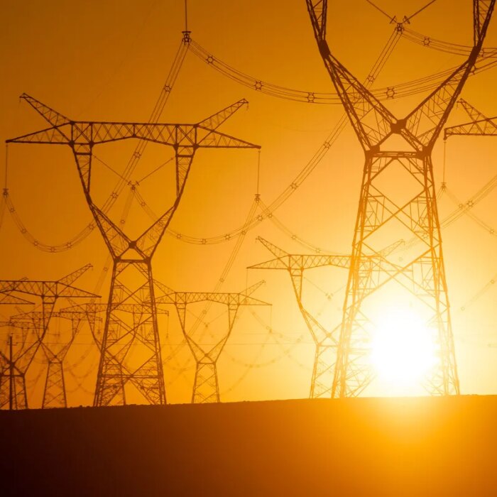 Silhouetted electricity pylon grid
